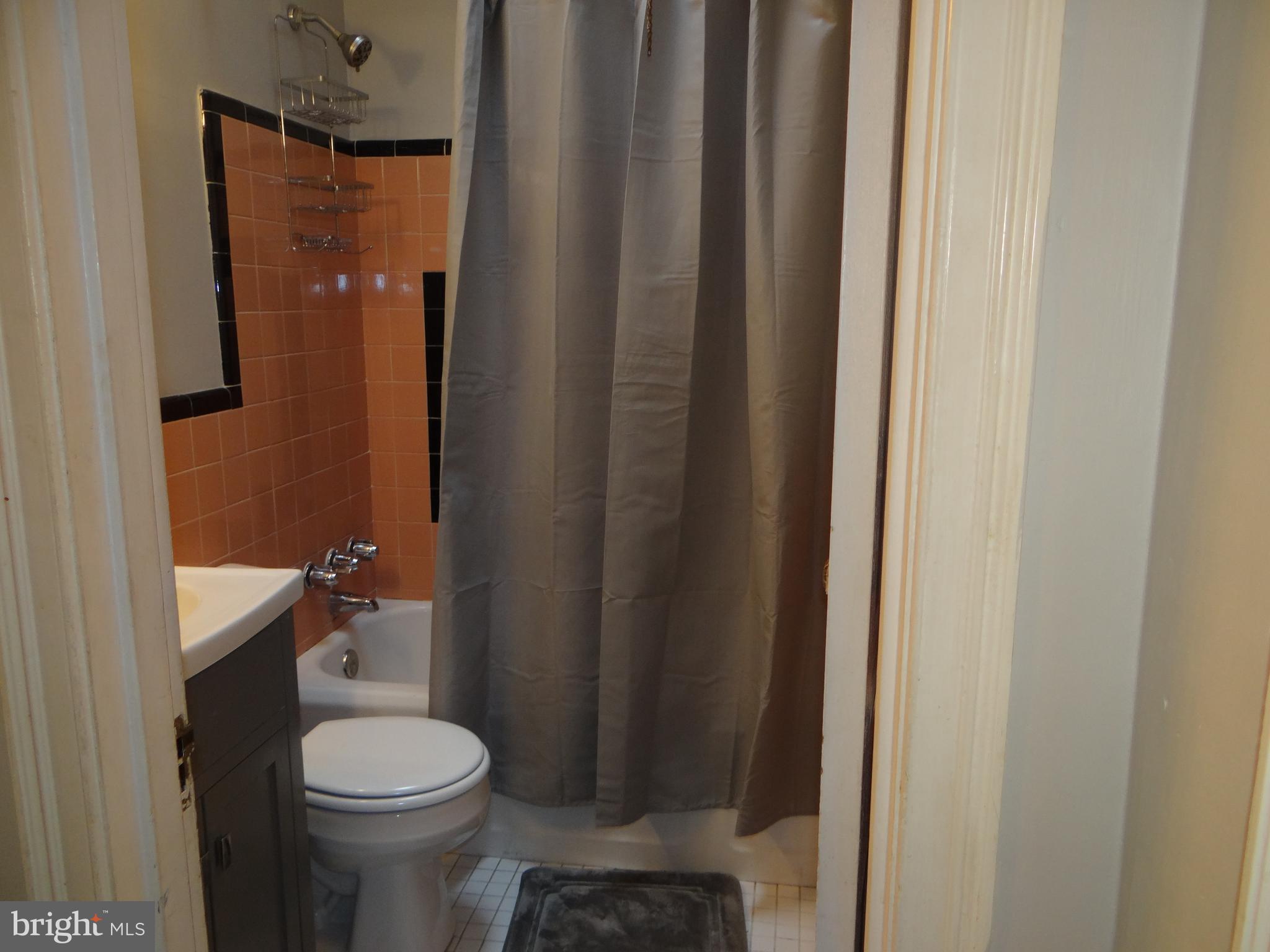 6744 Rutland Street Philadelphia, PA 19149 - Photo 19 of 44 a bathroom with a sink a toilet a shower and a window