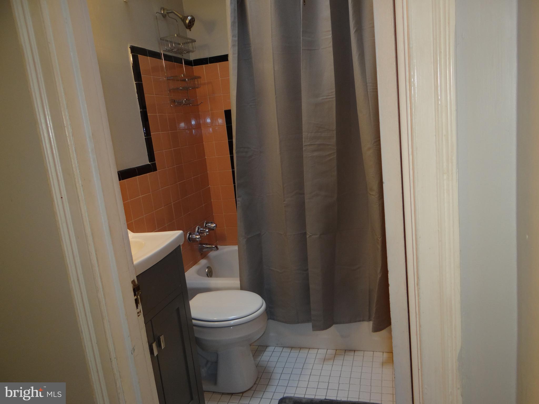6744 Rutland Street Philadelphia, PA 19149 - Photo 20 of 44 a white toilet sitting next to a shower curtain