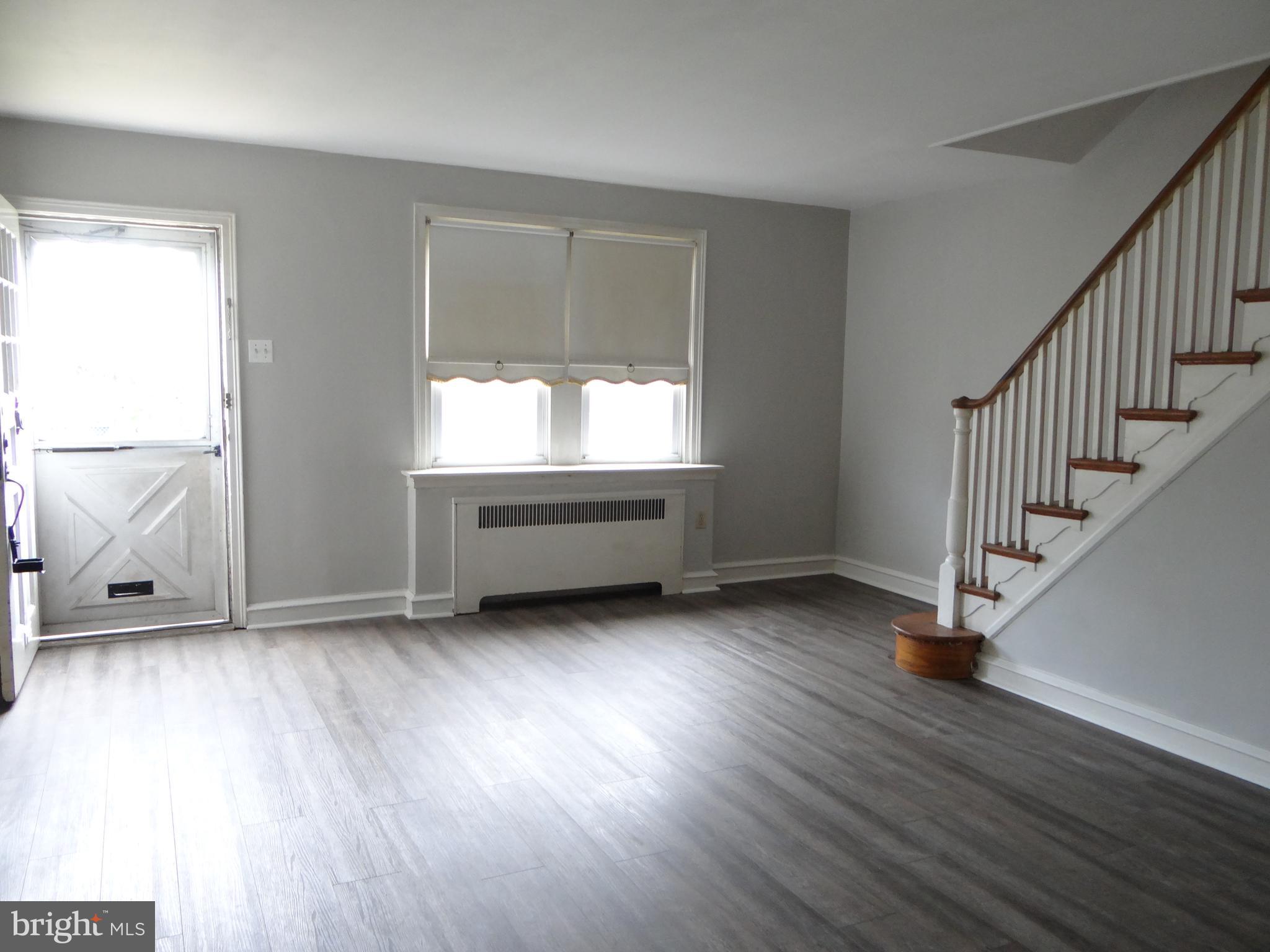 6744 Rutland Street Philadelphia, PA 19149 - Photo 5 of 44 an empty room with wooden floor and windows