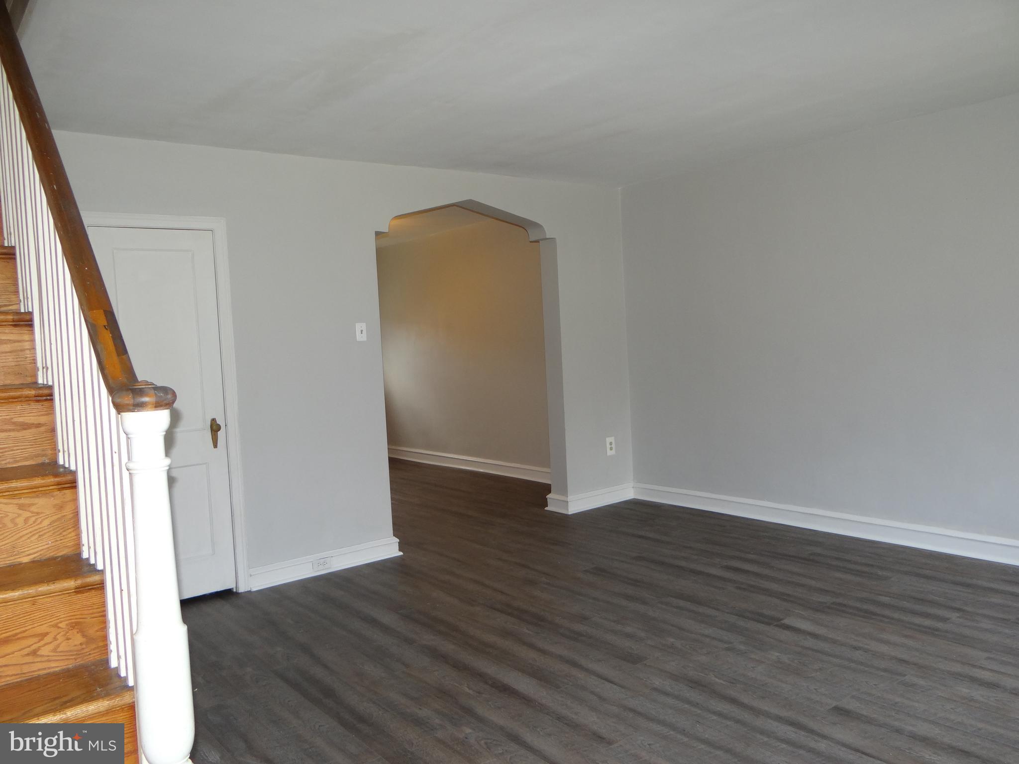 6744 Rutland Street Philadelphia, PA 19149 - Photo 8 of 44 a view of an empty room with wooden floor and stairs