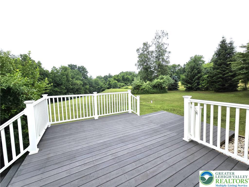 477 Quiet Valley Road Mount Bethel, PA 18343 - Photo 13 of 53 An inviting deck overlooks a verdant landscape, ideal for outdoor leisure.