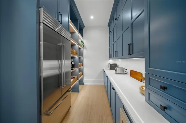 a bedroom with a large bed and a flat tv screen on dresser