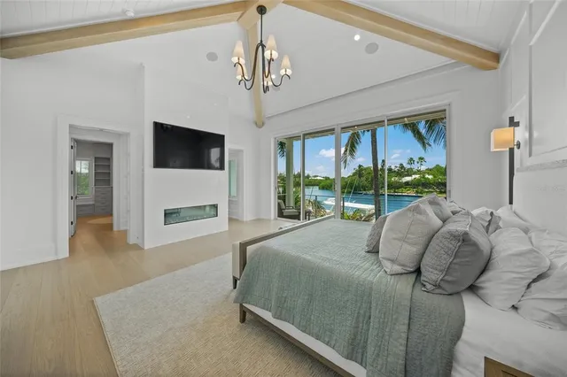 a bedroom with a bed couch tv and window