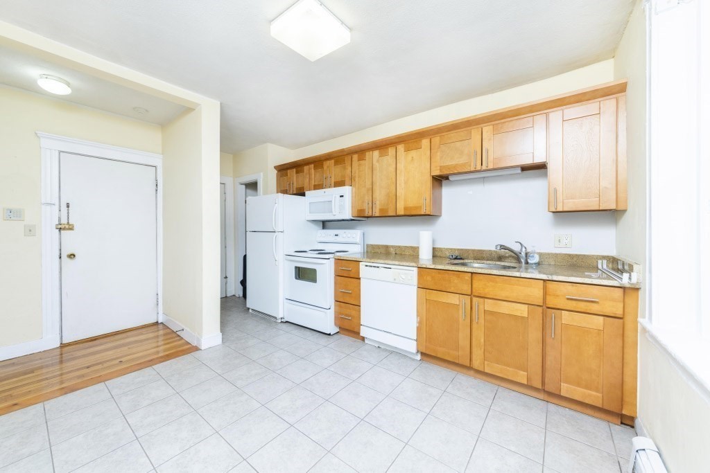 24 Ransom Road, Unit 8 Boston, MA 02135 - Photo 4 of 13 a kitchen with stainless steel appliances granite countertop a sink and cabinets