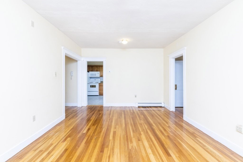 24 Ransom Road, Unit 8 Boston, MA 02135 - Photo 8 of 13 a view of a room with wooden floor and a ceiling fan