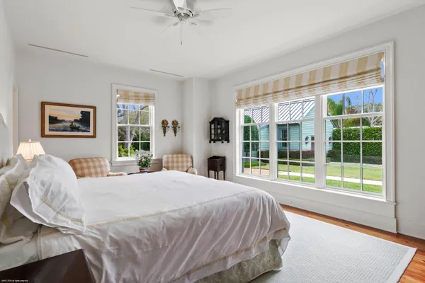 a bedroom with a bed and a large window