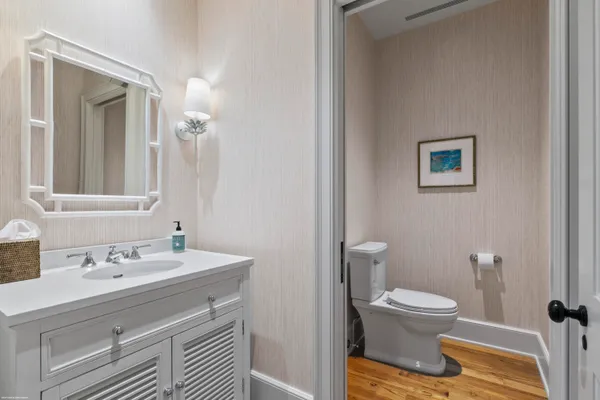 a bathroom with a sink toilet and mirror
