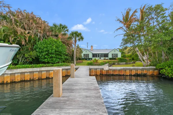 a view of house with yard outdoor seating and lake