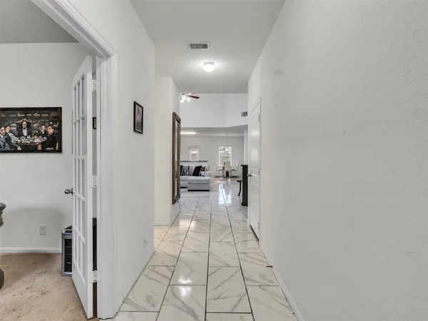a view of a hallway with a living room