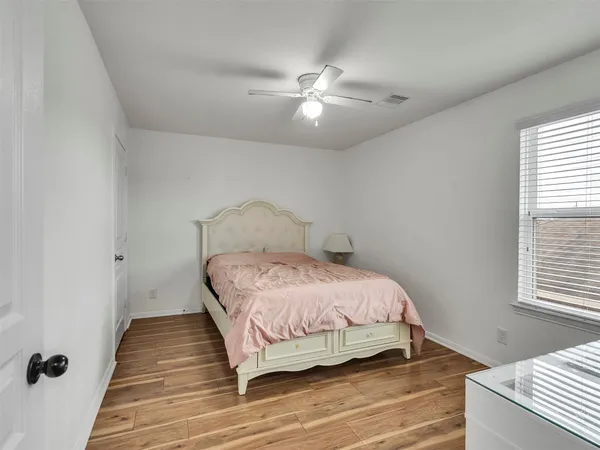 a bedroom with a bed and window