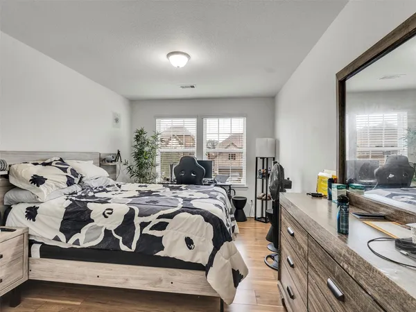 a bedroom with a bed and a large window