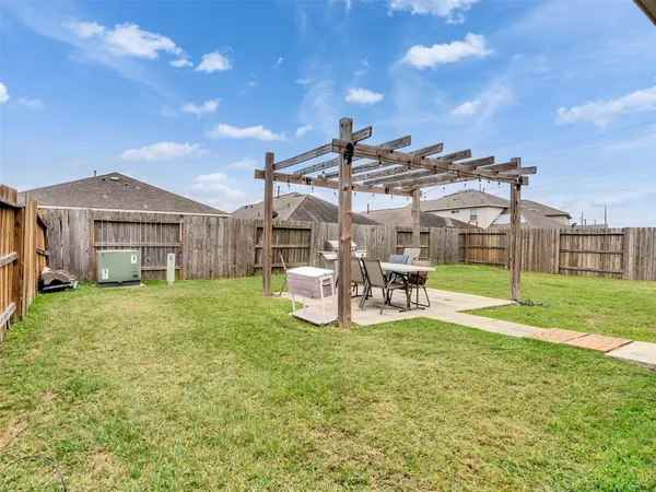a view of a house with a yard and sitting area