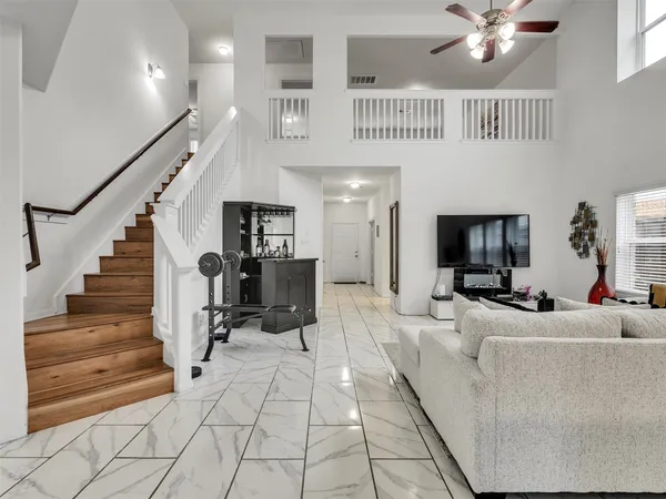 a living room with furniture and a chandelier