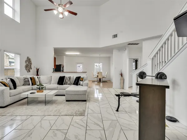 a living room with furniture and a chandelier