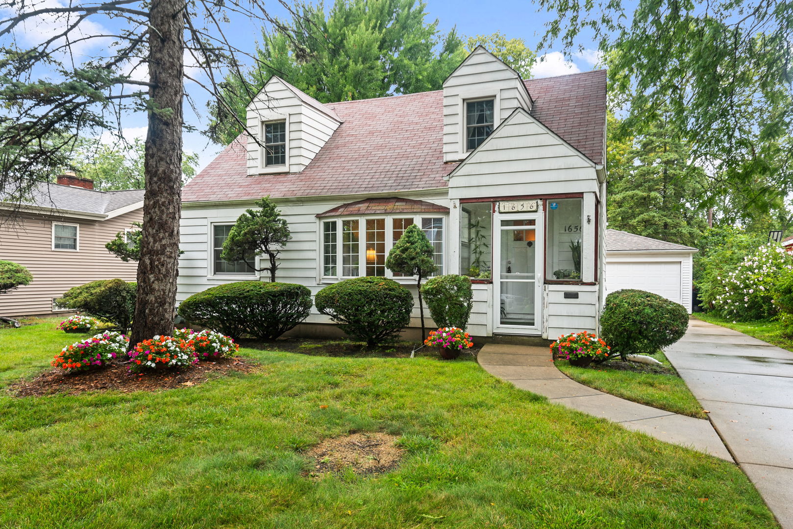 1656 Pine Road Homewood, IL 60430 - Photo 1 of 23 a front view of a house with a yard table and seating