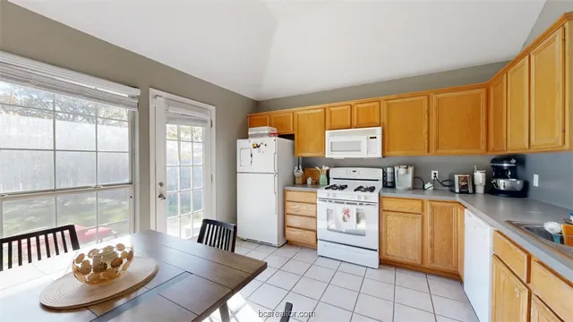 a kitchen with a sink appliances and cabinets