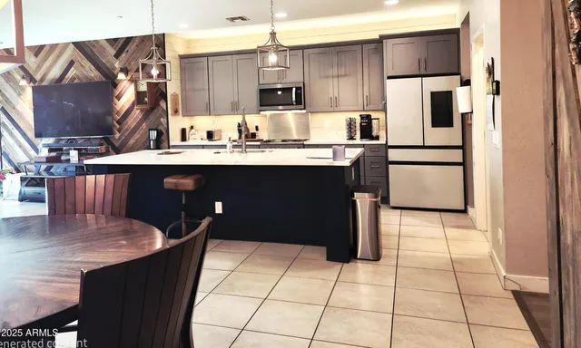 a bedroom with a bed and a lamp on dresser