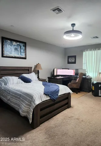 a bedroom with a bed and a mirror