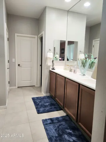 a bathroom with a double vanity sink and a mirror