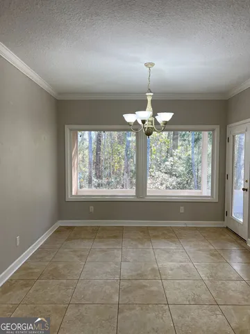 an empty room with a window and ceiling fan
