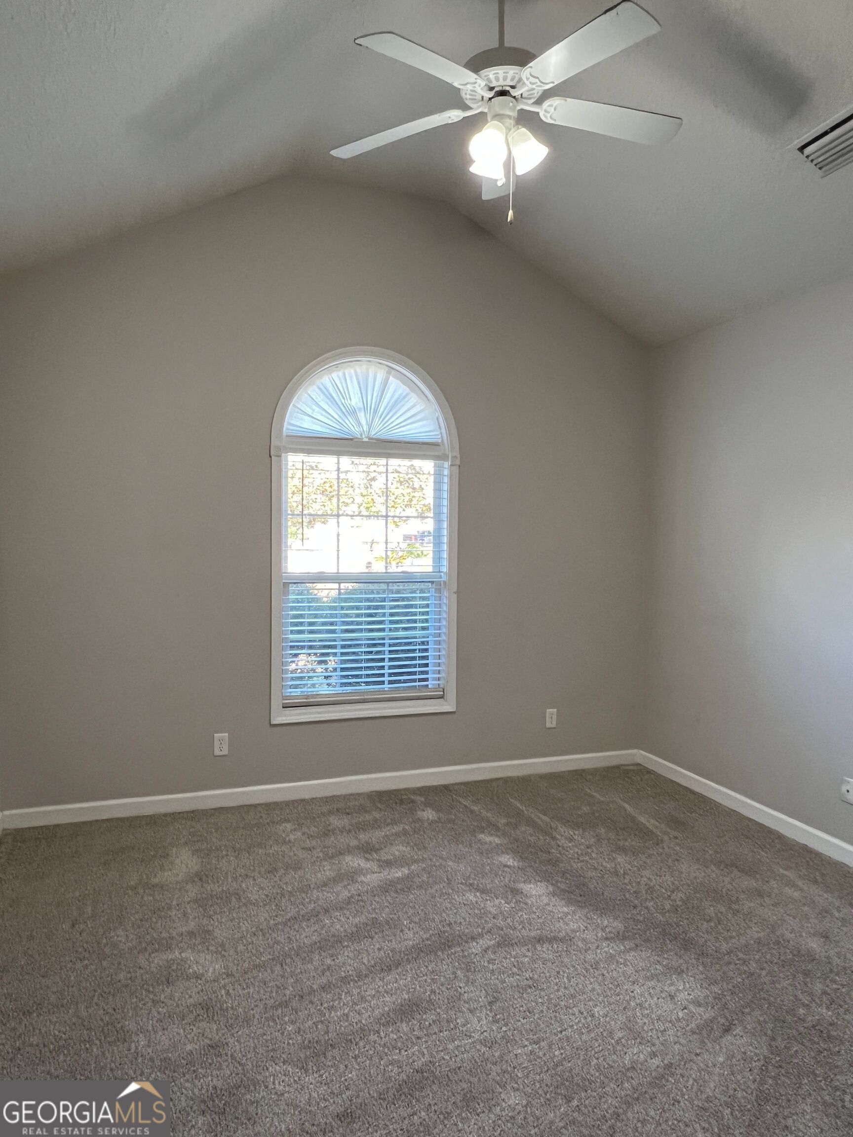 120 Renee Drive Kingsland, GA 31548 - Photo 20 of 23 an empty room with a chandelier fan and windows