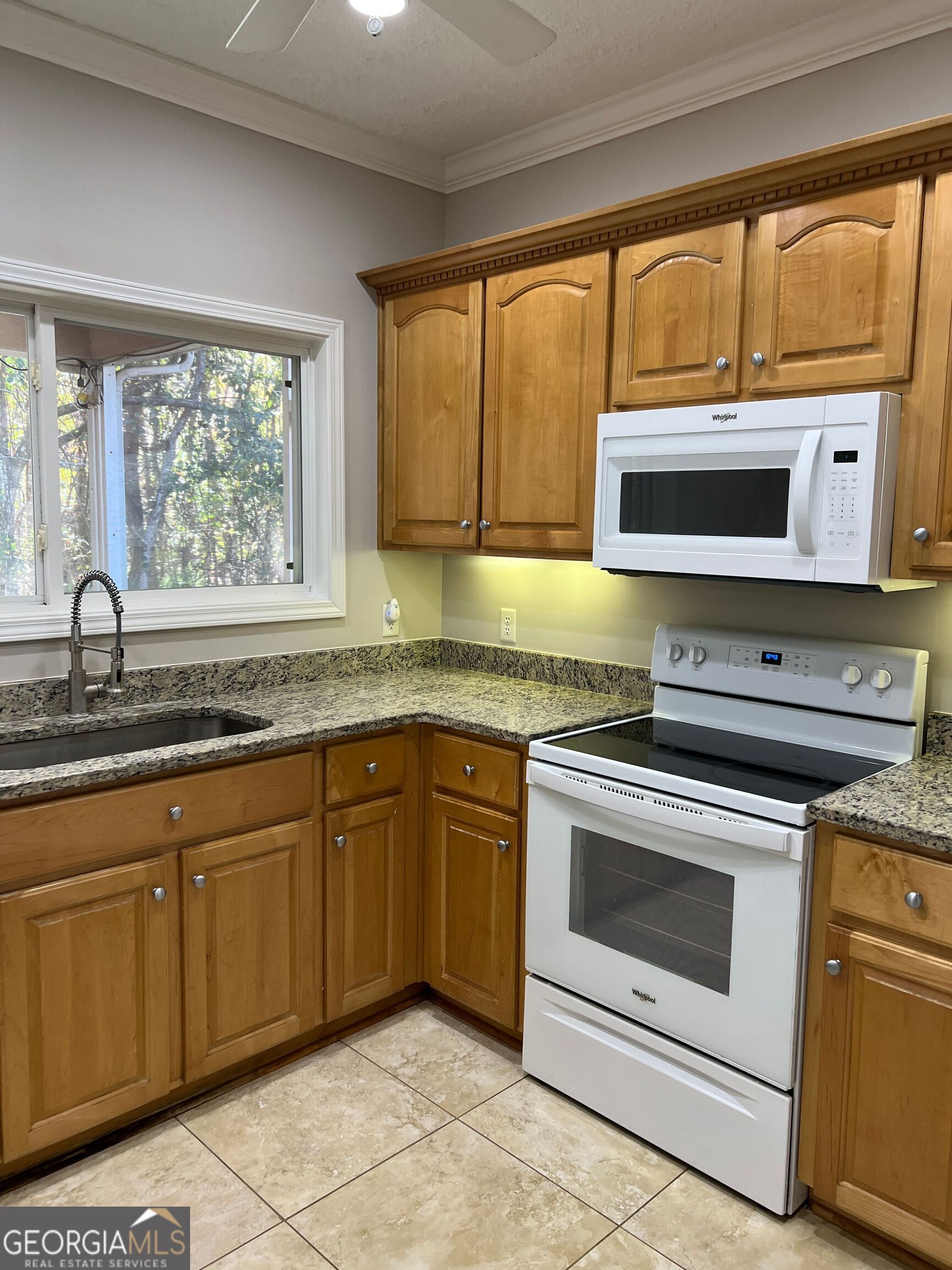 120 Renee Drive Kingsland, GA 31548 - Photo 6 of 23 a kitchen with granite countertop a stove and a sink