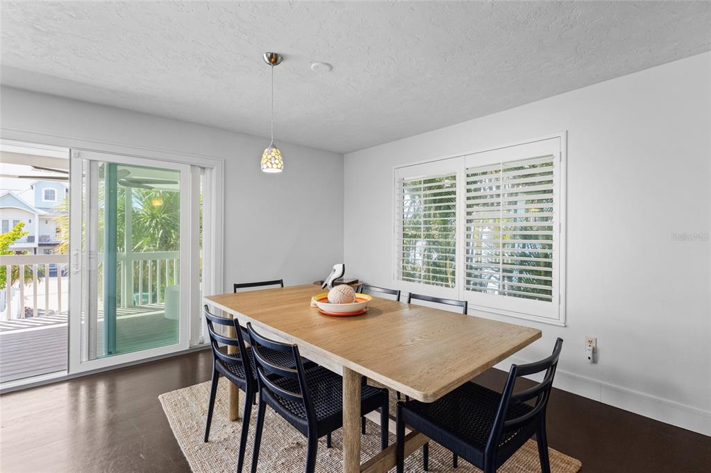 315 Spring Avenue Anna Maria, FL 34216 - Photo 17 of 63 a view of a dining room with furniture window and outside view