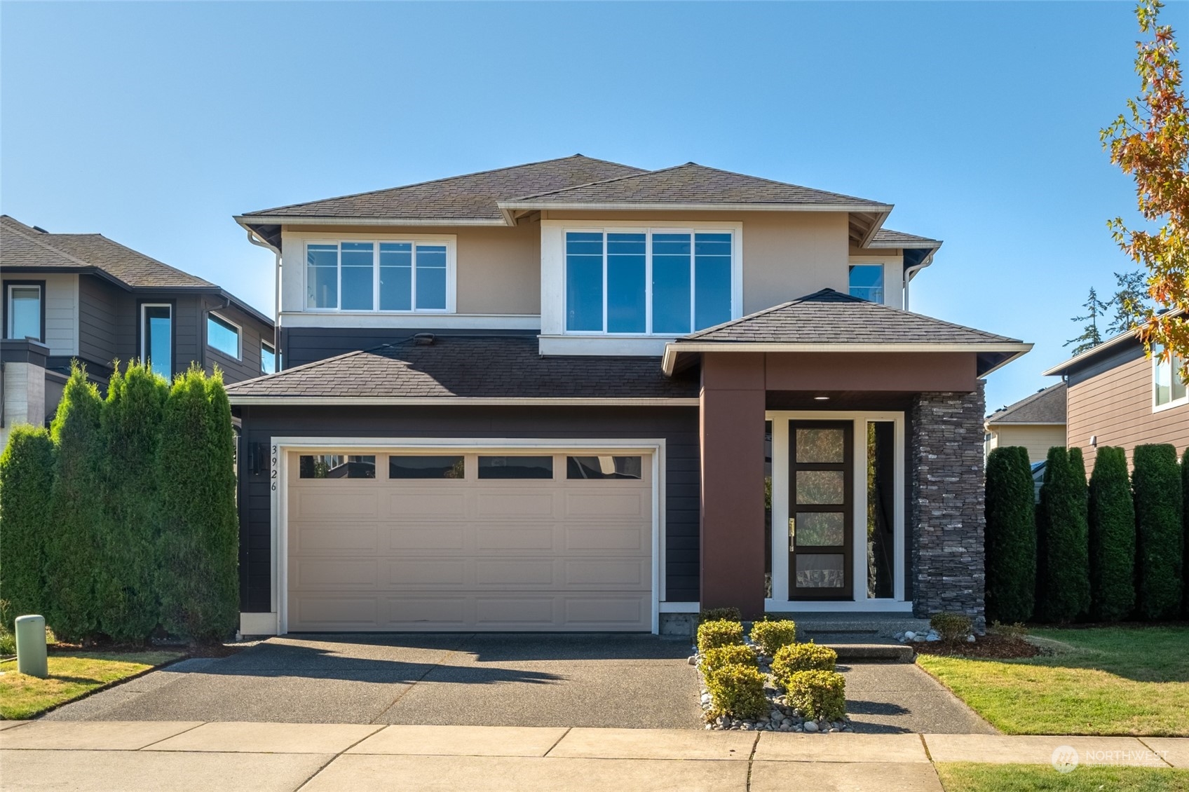 a front view of a house with a garden