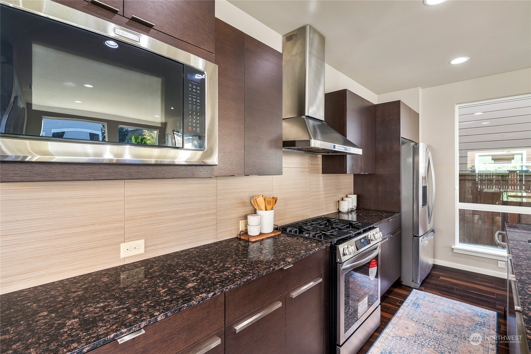 3926 171st Place Southeast Bothell, WA 98012 - Photo 12 of 40 a kitchen with stainless steel appliances granite countertop a sink and a stove