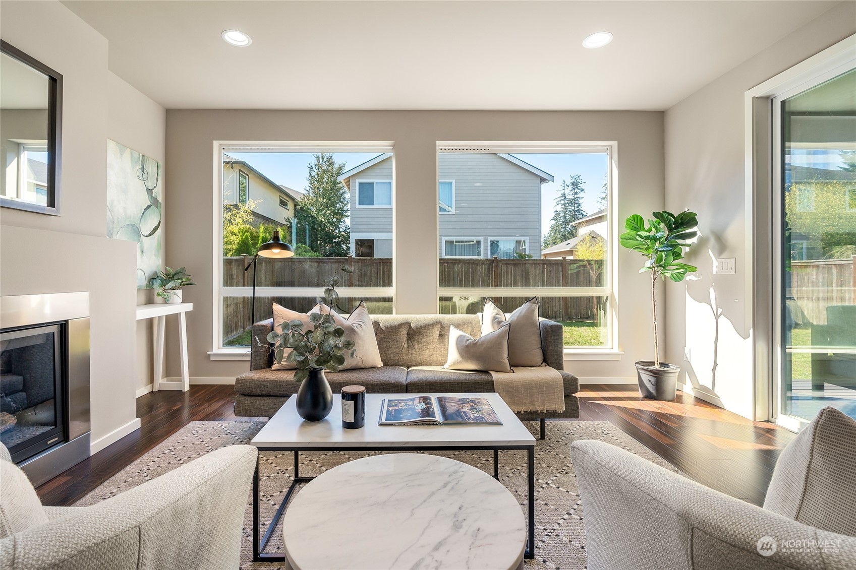 3926 171st Place Southeast Bothell, WA 98012 - Photo 2 of 40 a living room with furniture two large windows and a fireplace