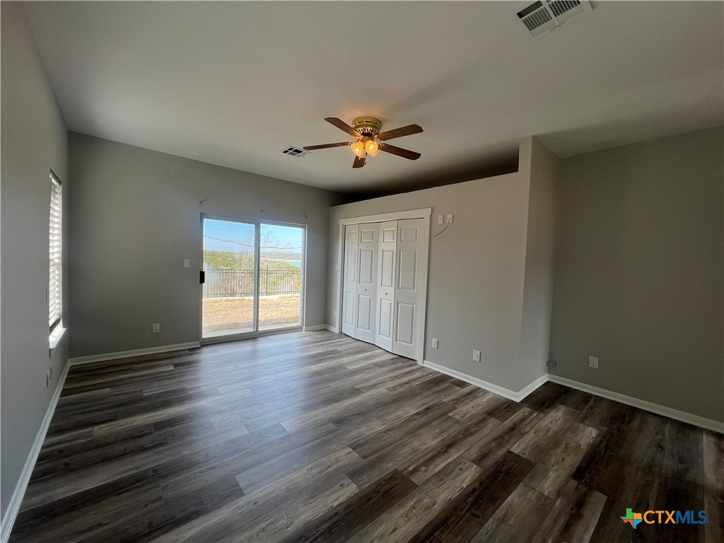 5899 Denmans Loop Belton, TX 76513 - Photo 13 of 35 wooden floor in an empty room with a window