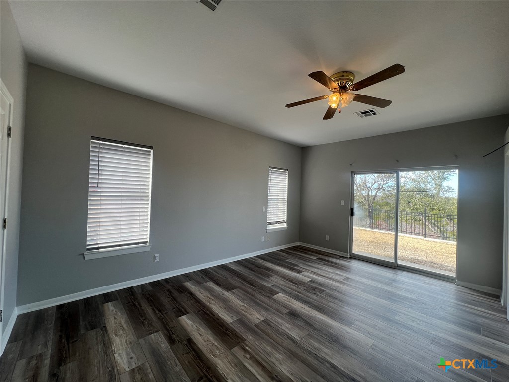 5899 Denmans Loop Belton, TX 76513 - Photo 14 of 35 a view of empty room with wooden floor and fan