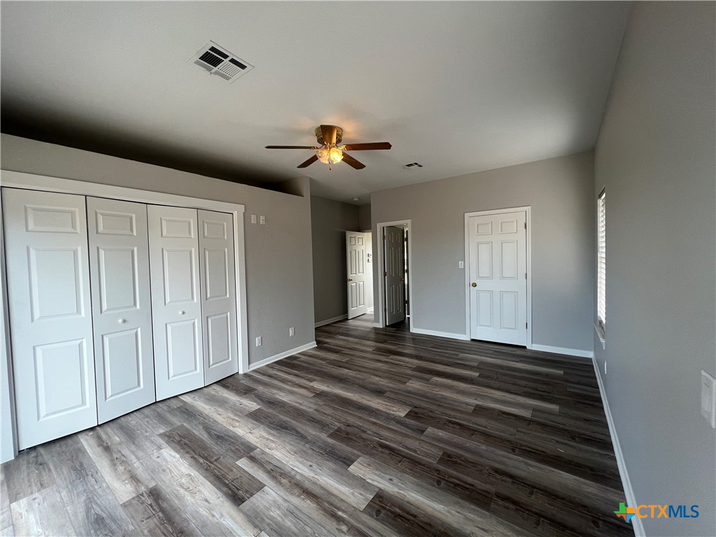 5899 Denmans Loop Belton, TX 76513 - Photo 16 of 35 a view of an empty room with wooden floor and cabinet