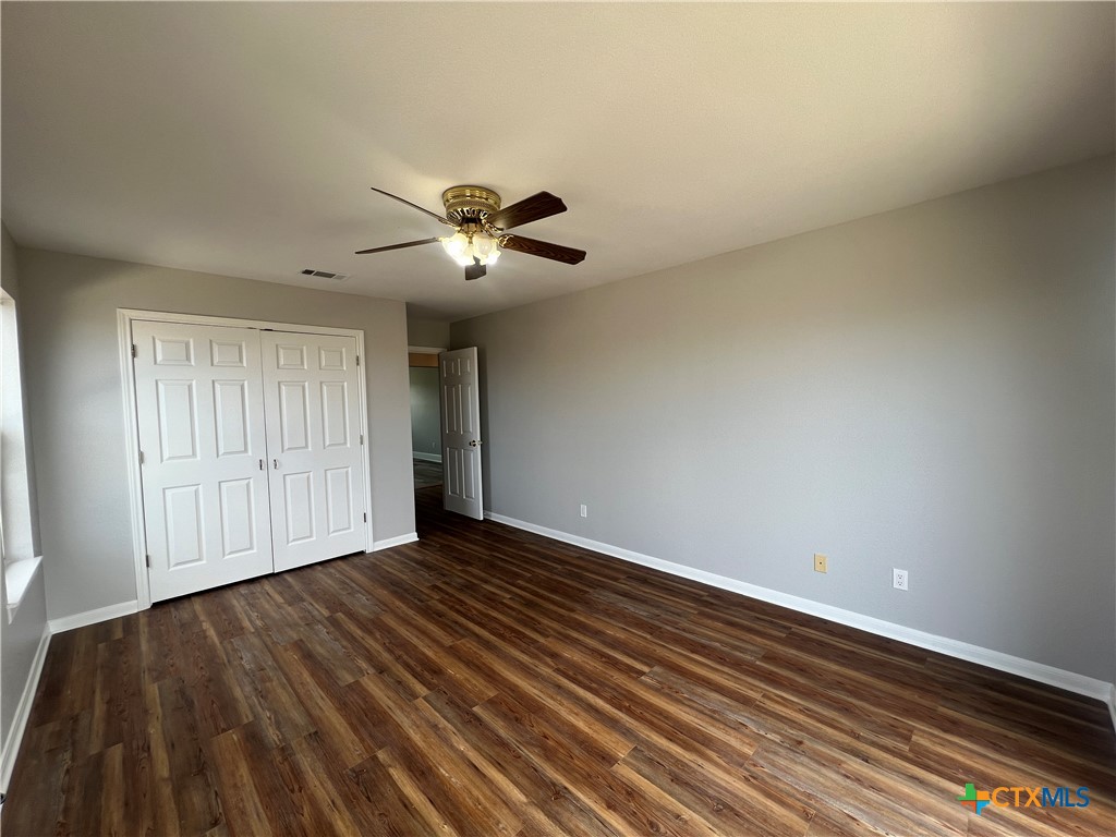 5899 Denmans Loop Belton, TX 76513 - Photo 29 of 35 a view of an empty room with a window and wooden floor