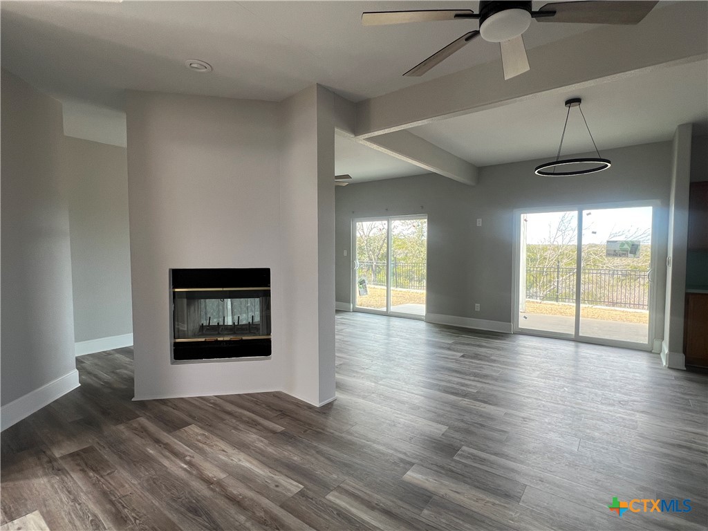 5899 Denmans Loop Belton, TX 76513 - Photo 3 of 35 a view of an empty room with a window and wooden floor