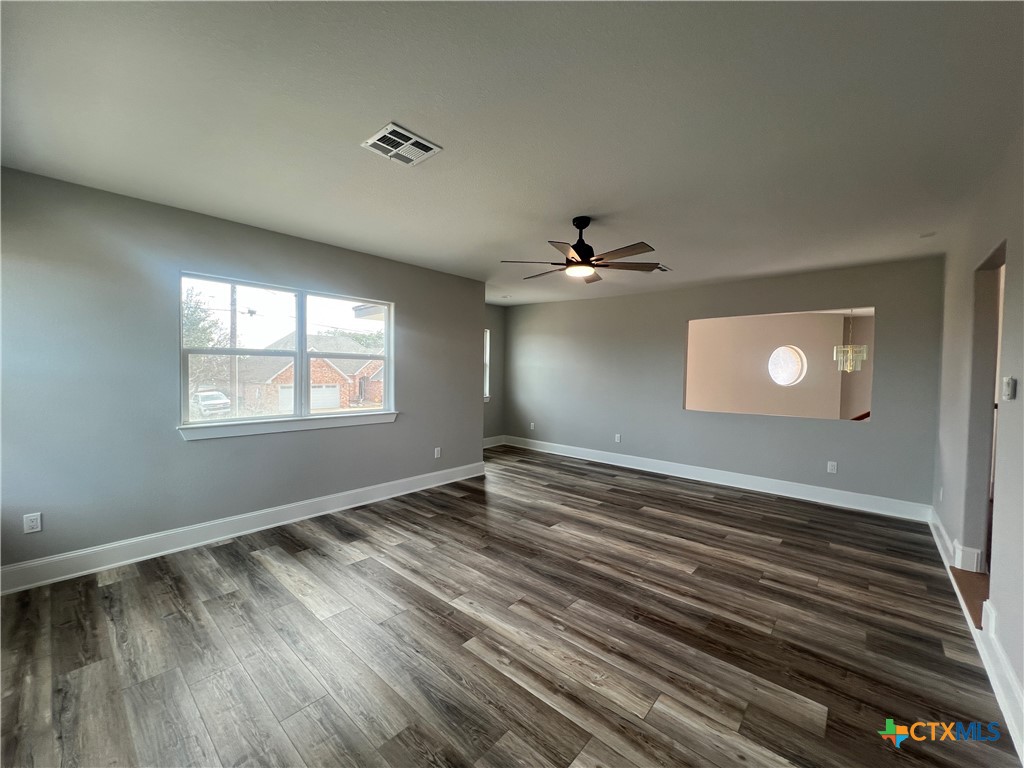 5899 Denmans Loop Belton, TX 76513 - Photo 31 of 35 a view of an empty room with window and wooden floor