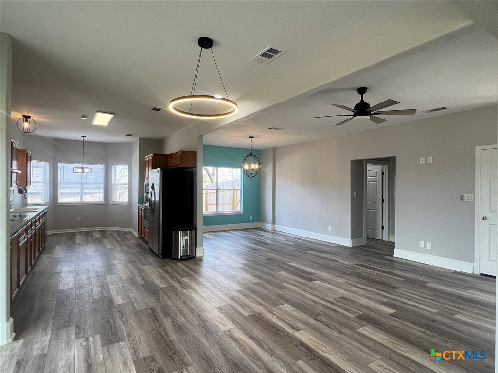 5899 Denmans Loop Belton, TX 76513 - Photo 4 of 35 a view of an empty room with a window and wooden floor
