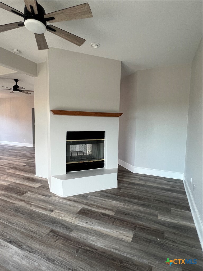 5899 Denmans Loop Belton, TX 76513 - Photo 6 of 35 a view of an empty room with wooden floor fireplace and a window