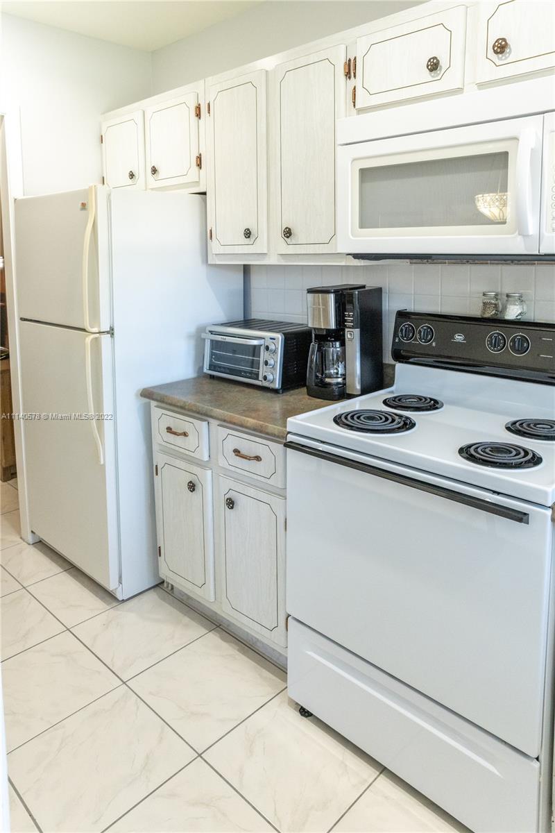 5300 Washington Street, Unit A234 Hollywood, FL 33021 - Photo 12 of 42 a kitchen with cabinets stainless steel appliances and a counter top space