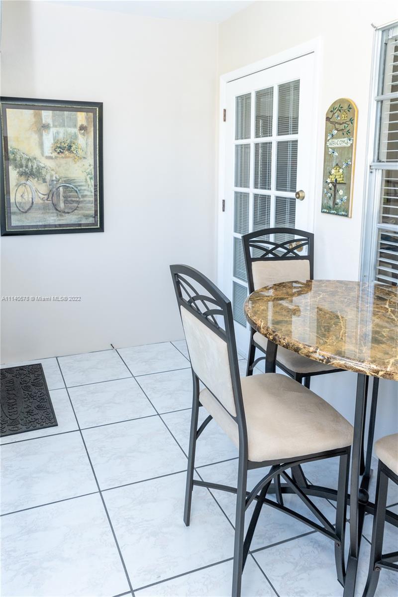 5300 Washington Street, Unit A234 Hollywood, FL 33021 - Photo 16 of 42 a dining room with furniture and window