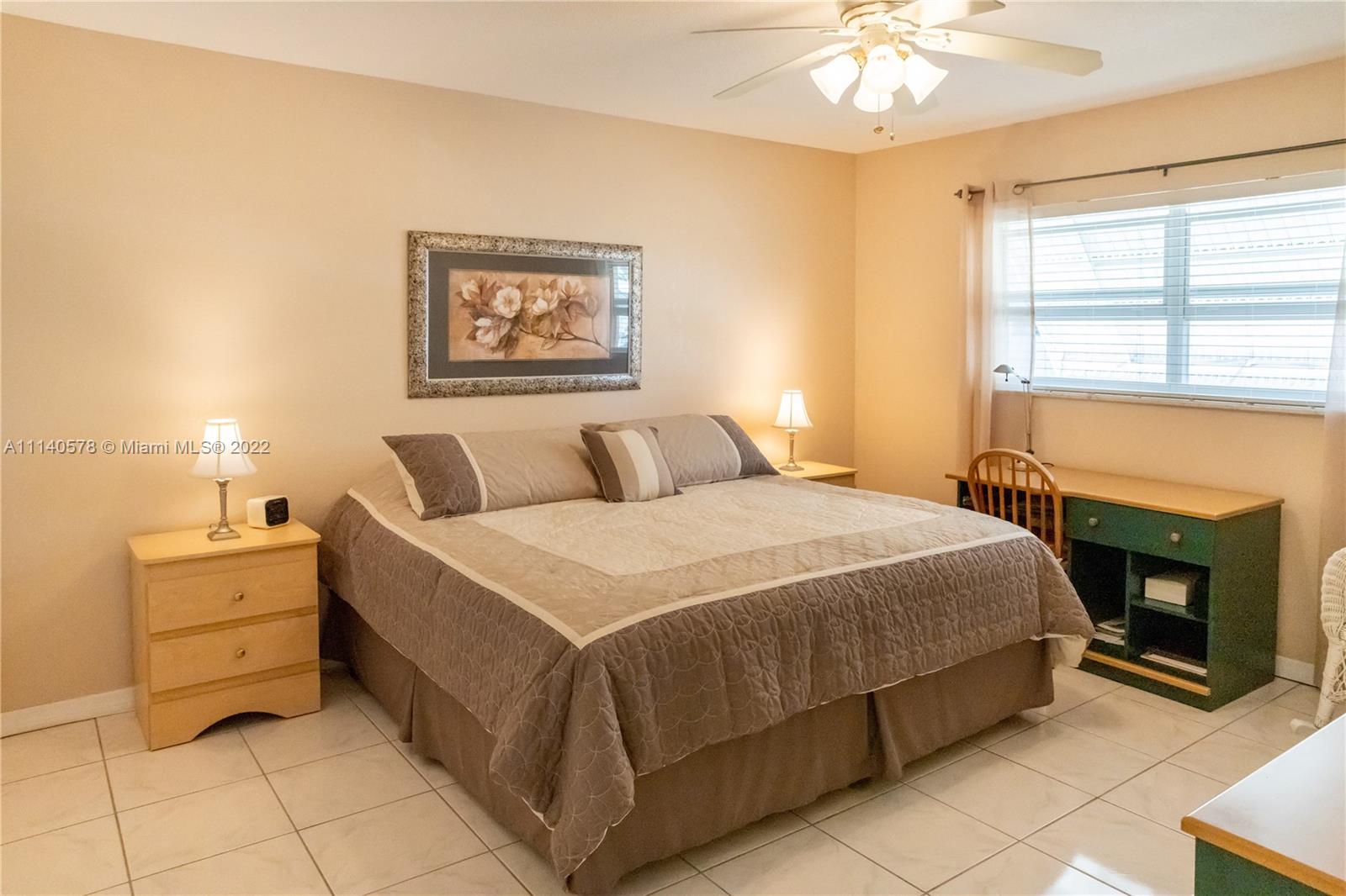 5300 Washington Street, Unit A234 Hollywood, FL 33021 - Photo 18 of 42 a bedroom with a bed and a fireplace