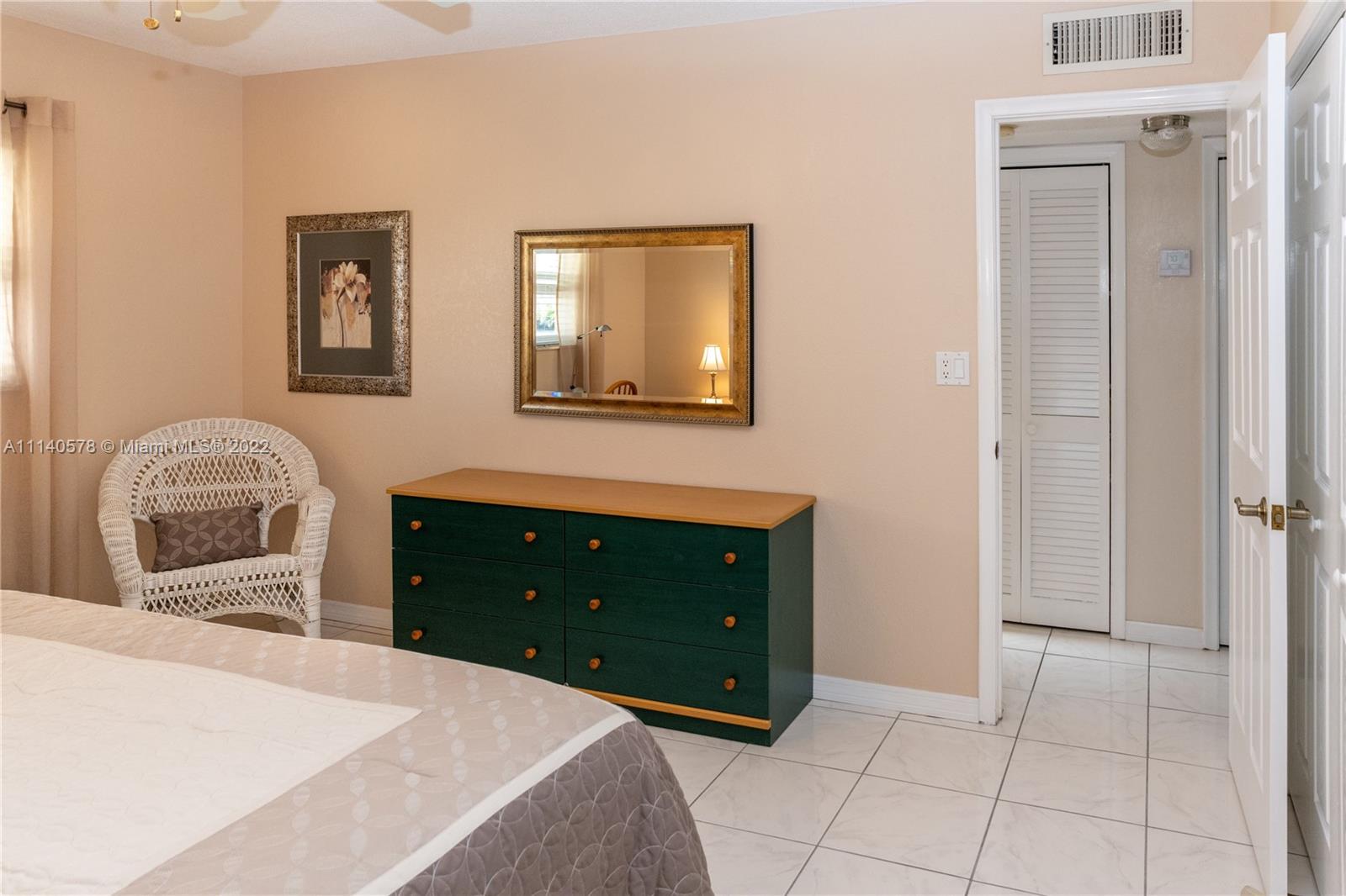 5300 Washington Street, Unit A234 Hollywood, FL 33021 - Photo 20 of 42 a bedroom with a bed and a dresser