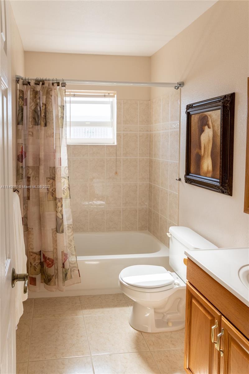 5300 Washington Street, Unit A234 Hollywood, FL 33021 - Photo 21 of 42 a bathroom with a toilet a sink and a shower