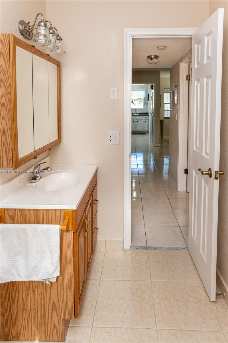 5300 Washington Street, Unit A234 Hollywood, FL 33021 - Photo 22 of 42 a spacious bathroom with a mirror and a sink