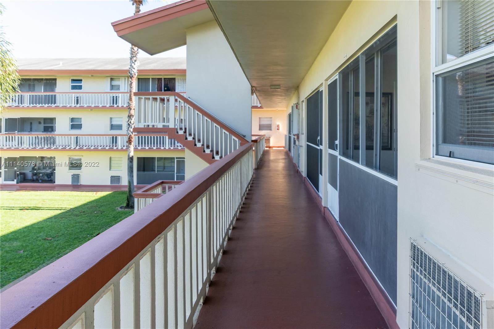 5300 Washington Street, Unit A234 Hollywood, FL 33021 - Photo 23 of 42 a view of staircase with wooden floor and fence