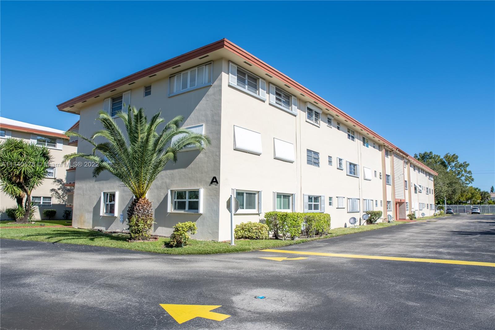 5300 Washington Street, Unit A234 Hollywood, FL 33021 - Photo 30 of 42 a front view of residential houses with street and trees