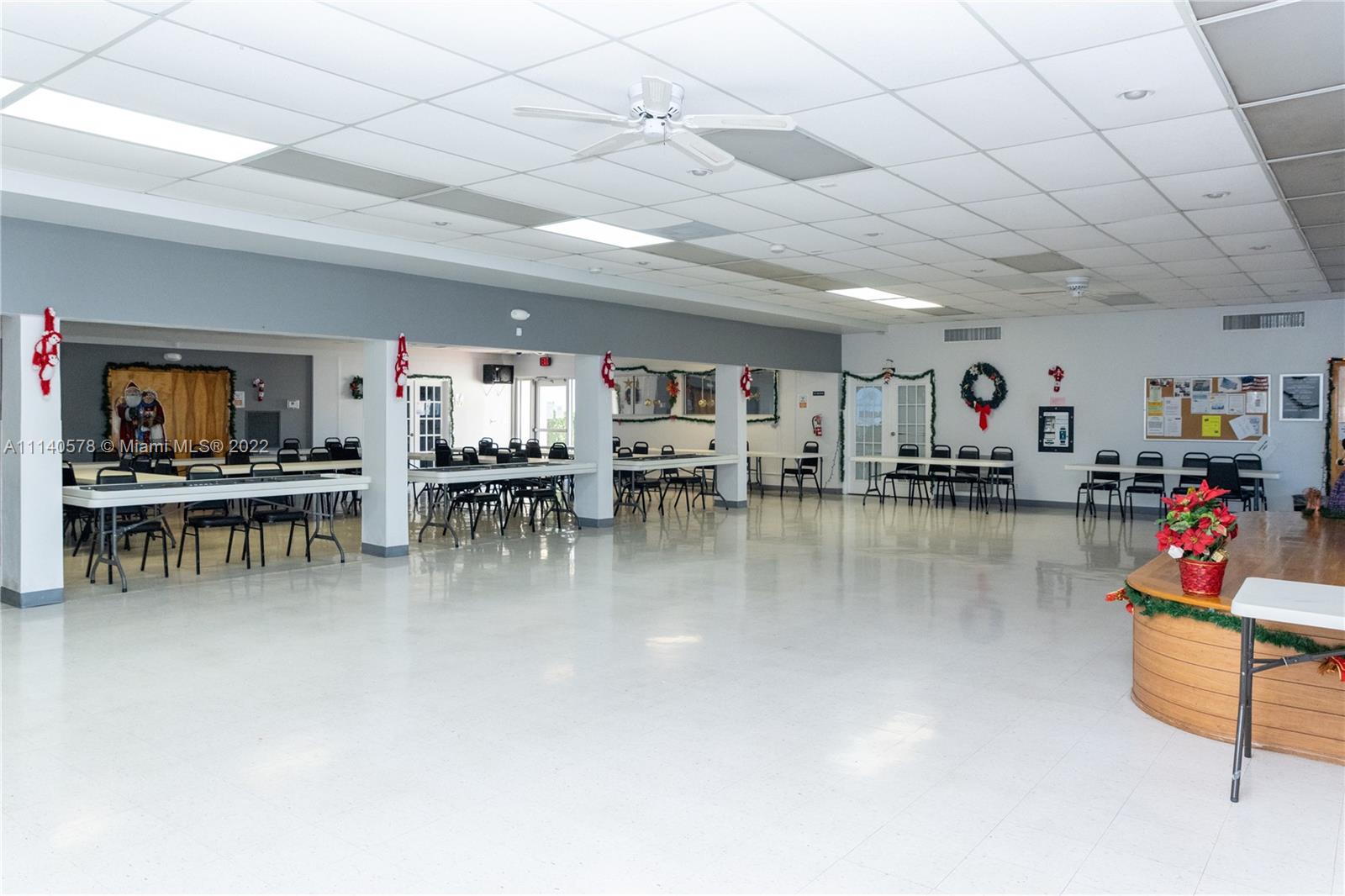 5300 Washington Street, Unit A234 Hollywood, FL 33021 - Photo 33 of 42 a living room with lots of furniture and a kitchen view