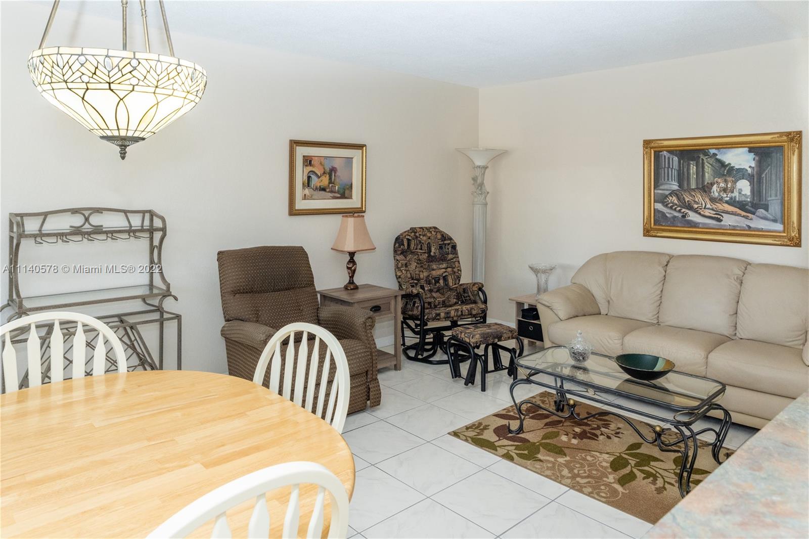 5300 Washington Street, Unit A234 Hollywood, FL 33021 - Photo 5 of 42 a living room with furniture a rug and a chandelier