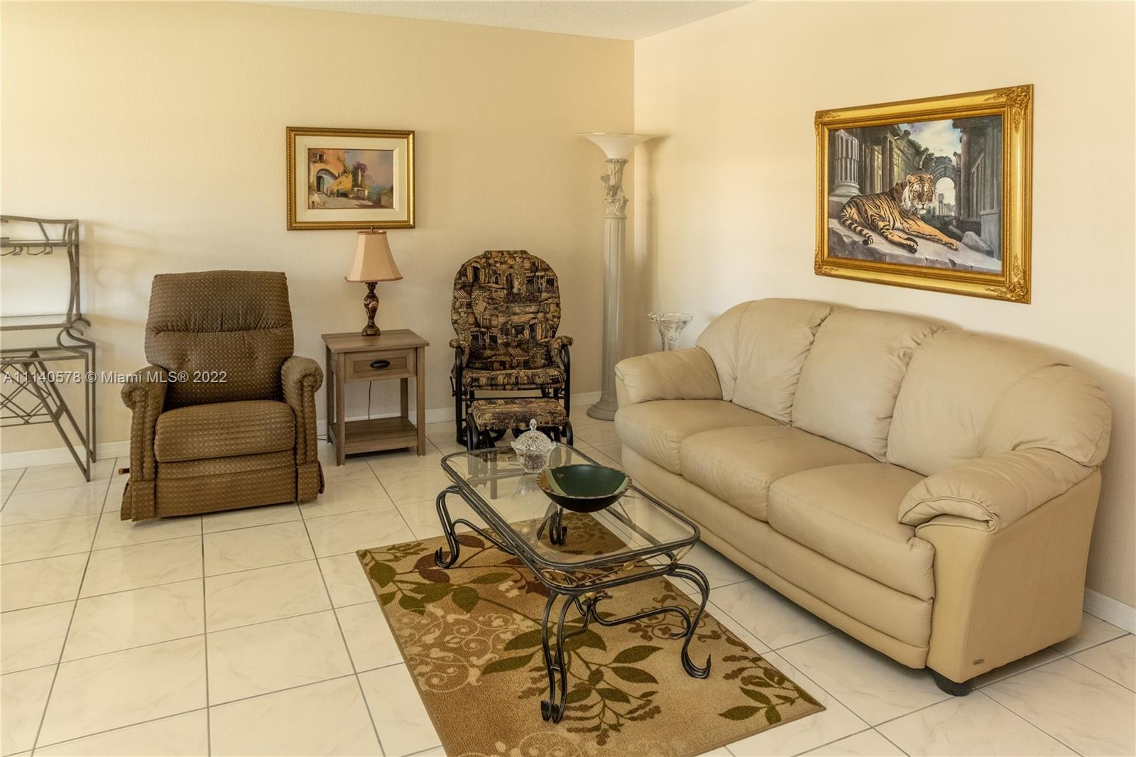 5300 Washington Street, Unit A234 Hollywood, FL 33021 - Photo 6 of 42 a living room with furniture and a painting on the wall