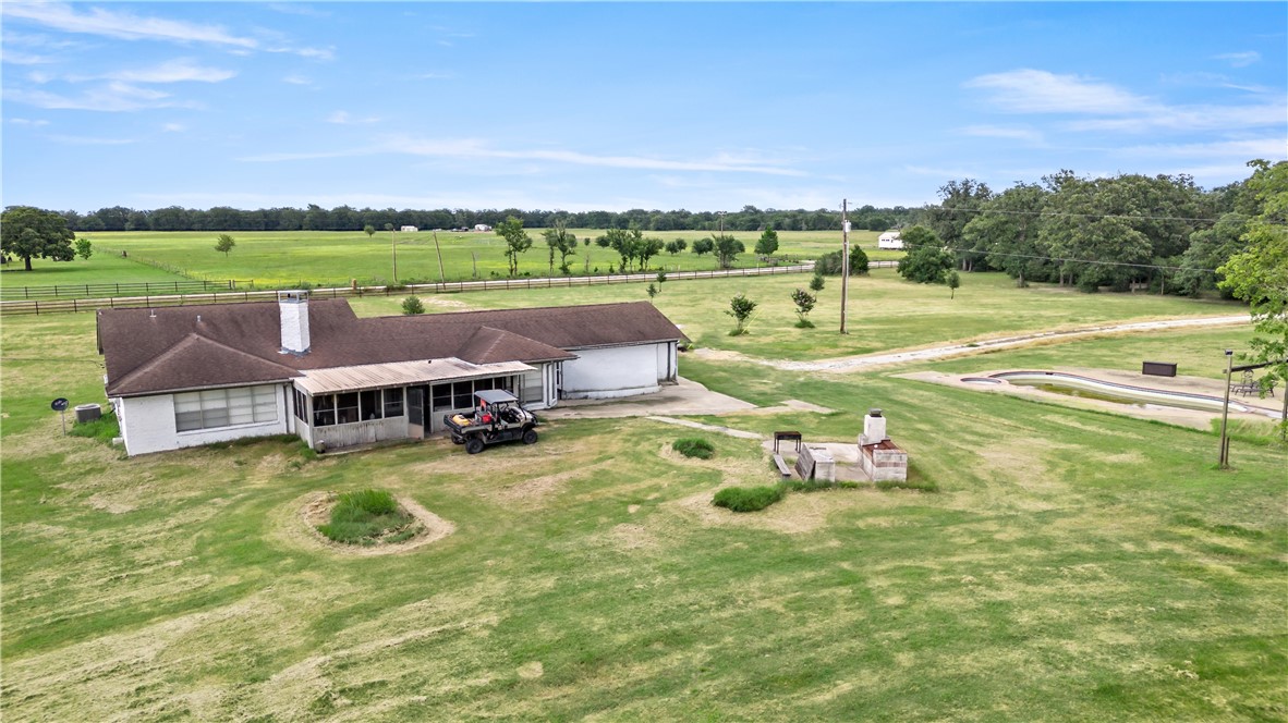 8166 Riley Road Bryan, TX 77808 - Photo 10 of 35 a view of a swimming pool and trees in the background